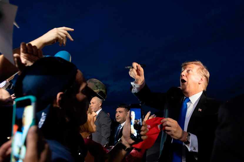 President Donald Trump is greeted by supporters upon his arrival in West Palm Beach,...