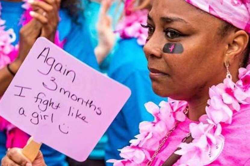 black woman dressed in pink with a breast cancer sign that reads again 3 months I fight like...