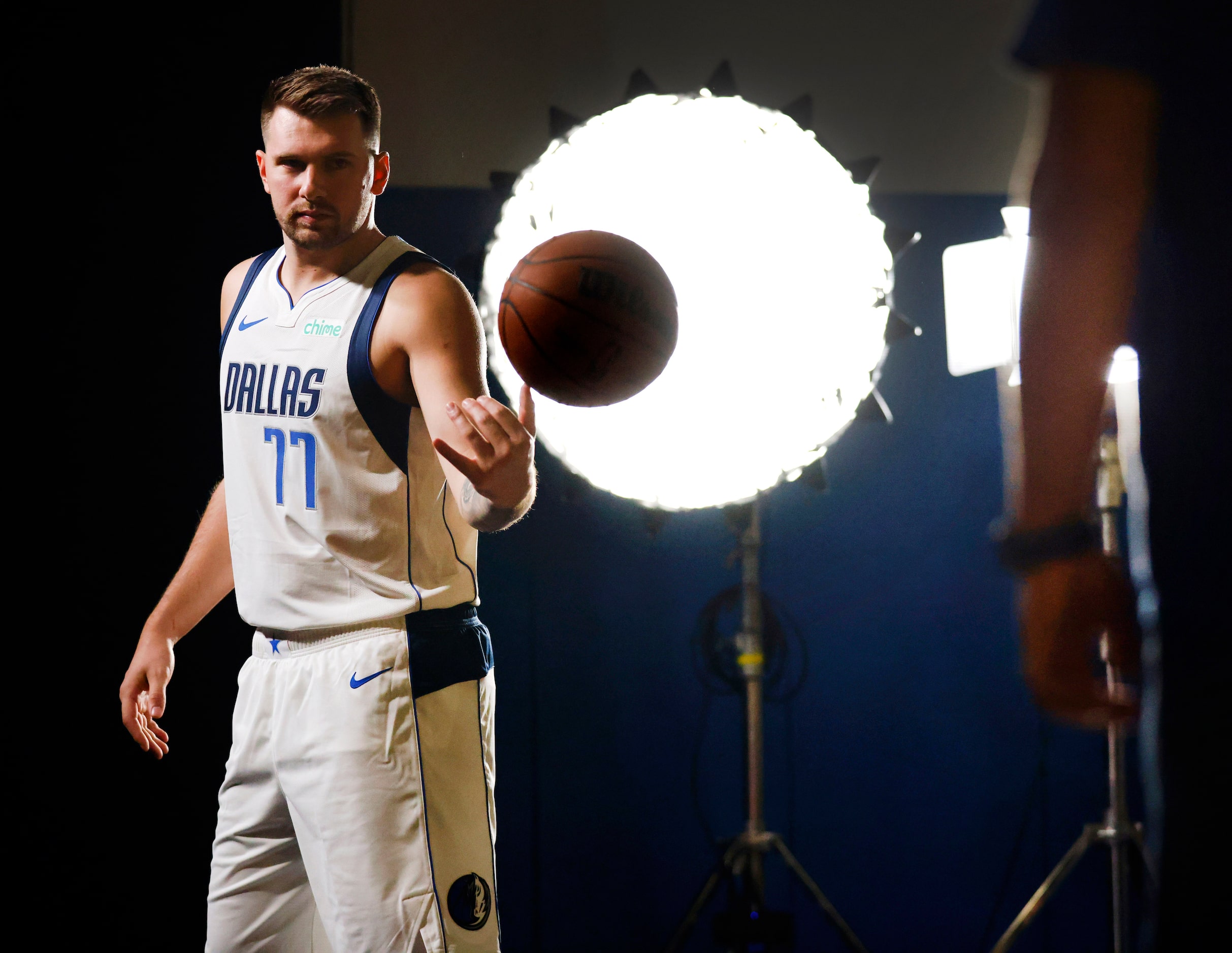 Dallas Mavericks guard Luka Doncic flips a basketball to a crewman as he was filmed for a...