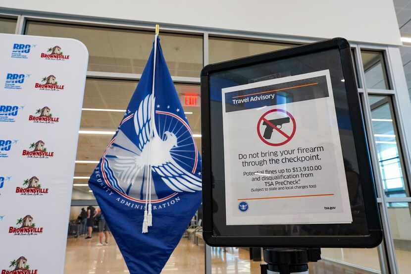 A sign advises travelers not to bring their firearm through the Transportation Security...
