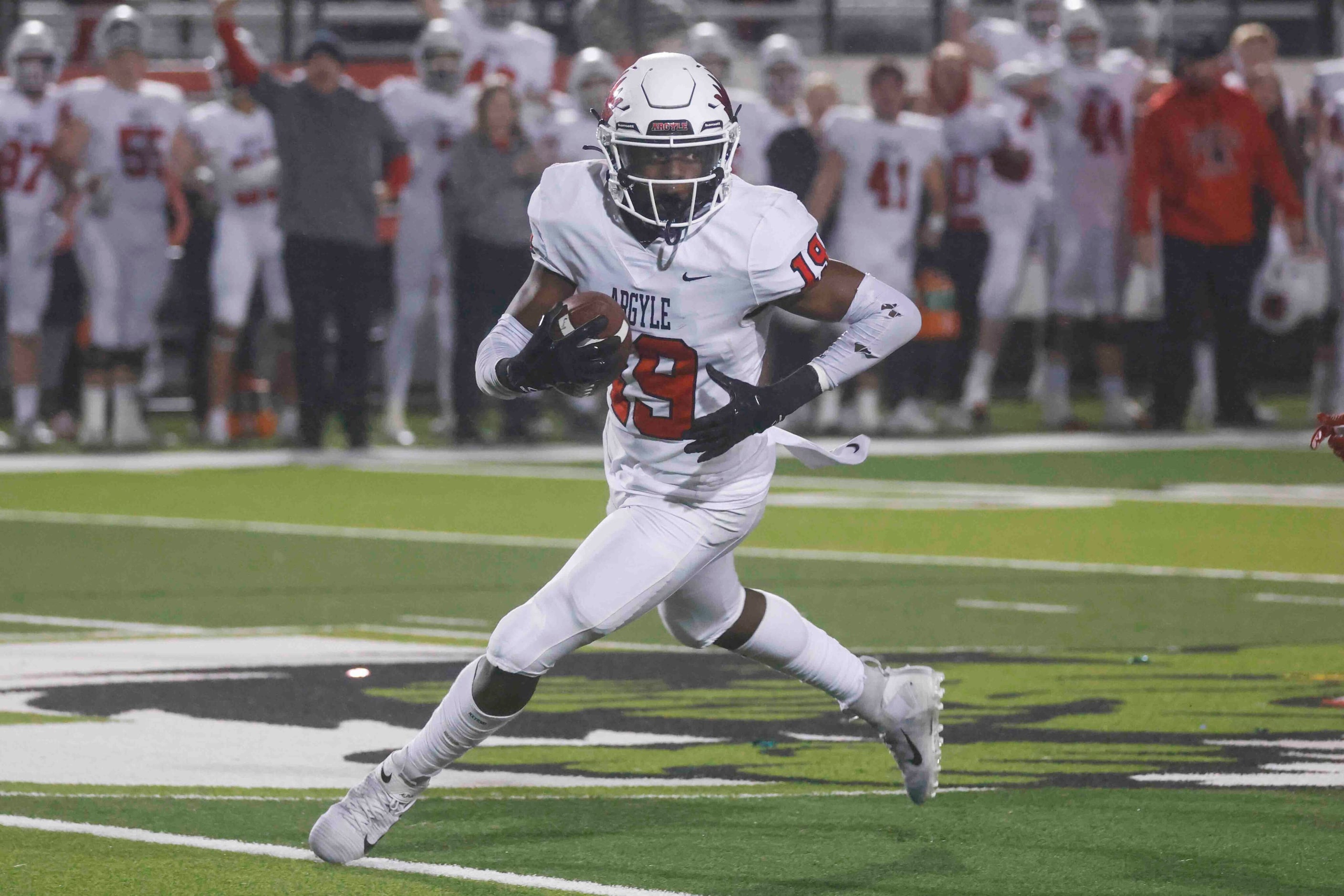 Argyle High’s Jaaqwan Felton (19) runs after he intercepts a pass against Grapevine High...