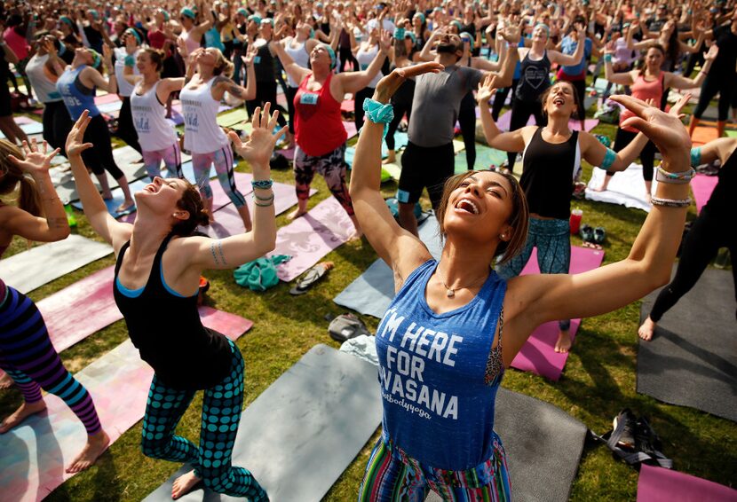 Yoga enthusiasts participate in the Wanderlust group yoga and mediation session following...