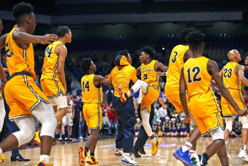 Oak Cliff celebrates after Oak Cliff Faith Academy's Jordan Walsh #23,far right hit the...