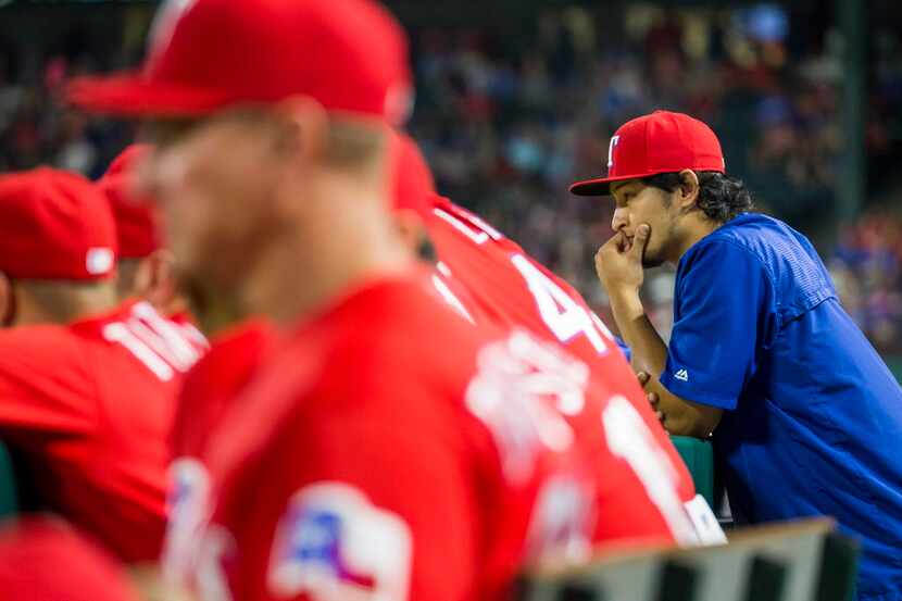 Texas Rangers starting pitcher Yu Darvish watches from the dugout during the ninth inning of...
