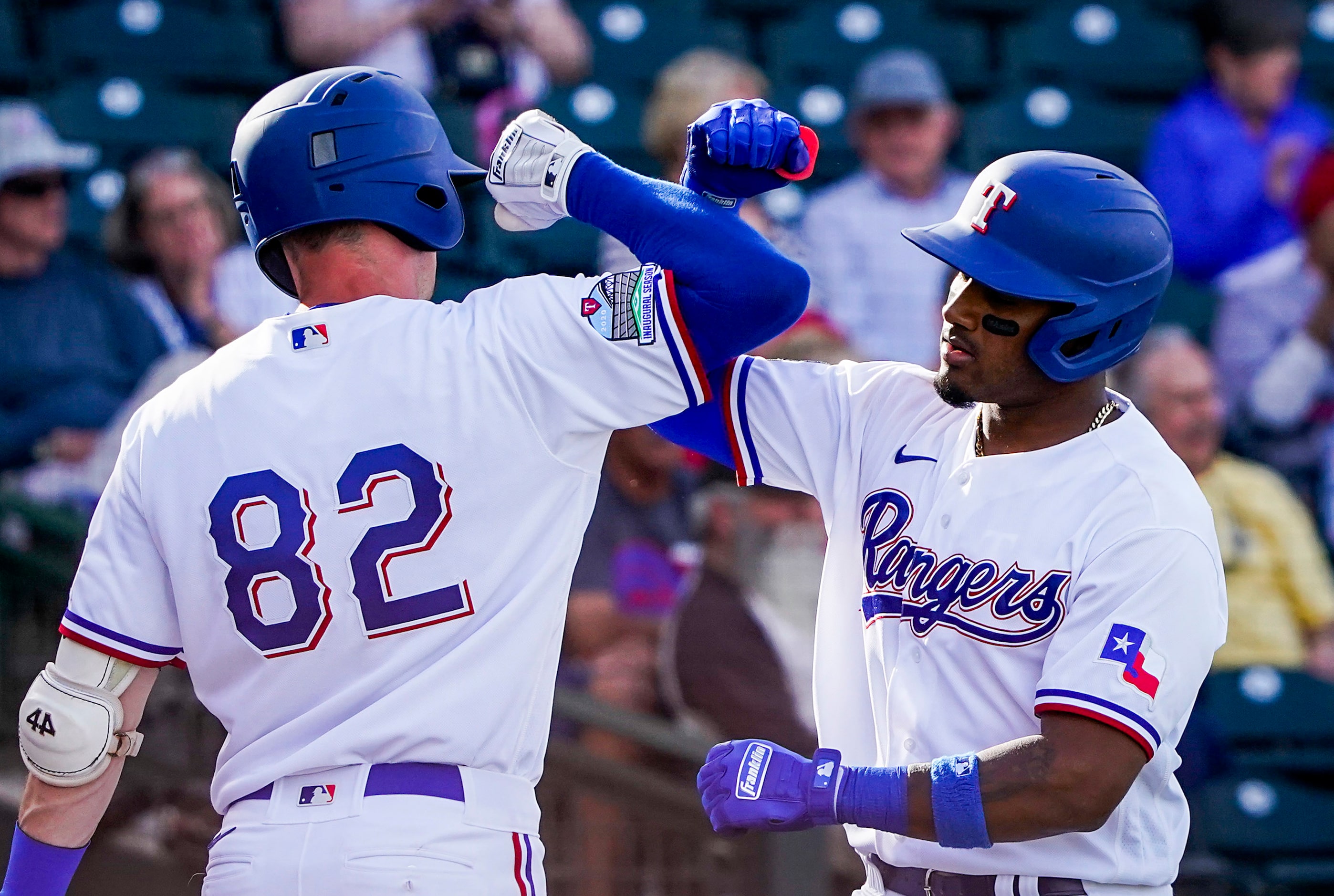 Texas Rangers infielder Andy Ibanez celebrates with first baseman Josh Altmann after hitting...