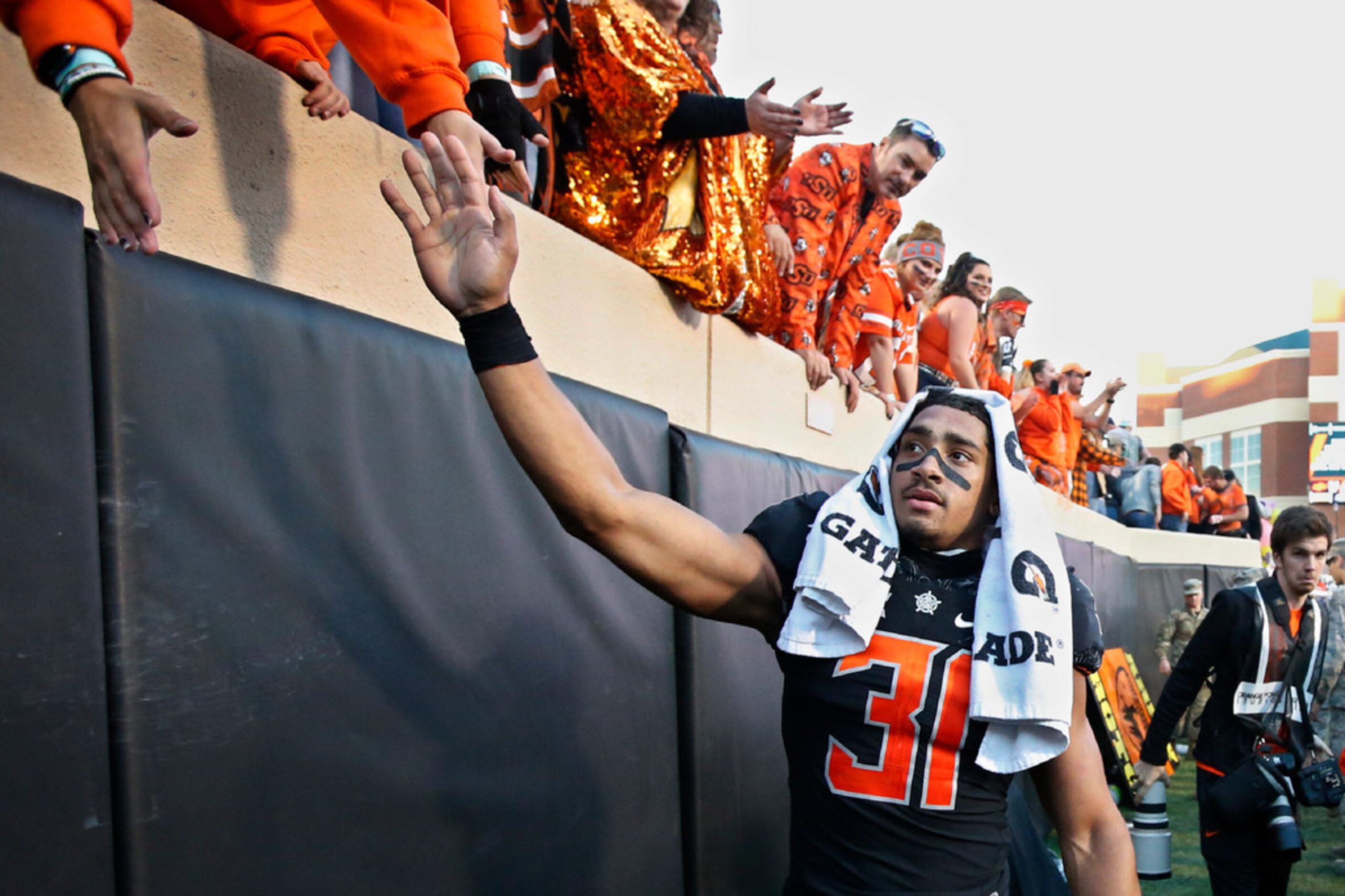 Oklahoma State running back Chuba Hubbard (30) celebrates with fans following an NCAA...