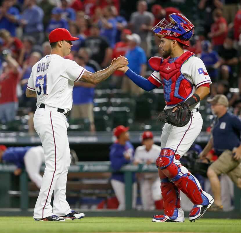 Texas Rangers relief pitcher Matt Bush (51) and catcher Robinson Chirinos (61) celebrate a...