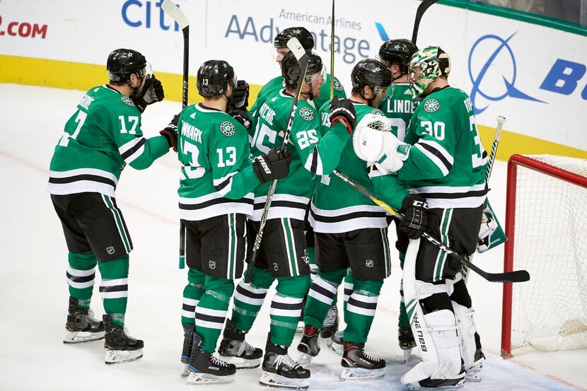 The Dallas Stars celebrate after defeating the San Jose Sharks in an NHL hockey game Friday,...