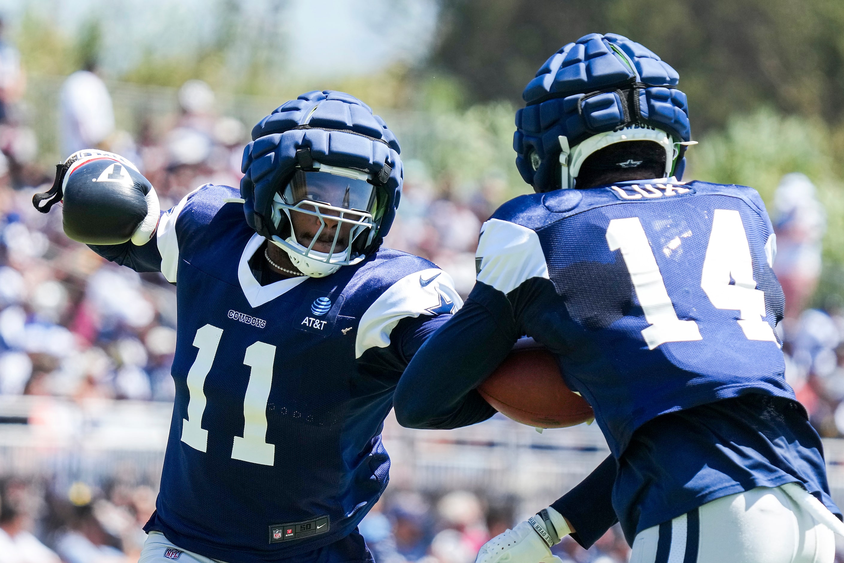 Dallas Cowboys linebacker Micah Parsons (11) tries to punch the ball away from linebacker...