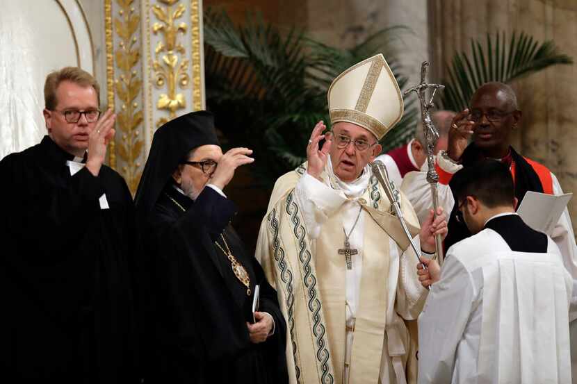 Pope Francis, center, delivers delivers a blessing at the end of a Vespers' service at the...