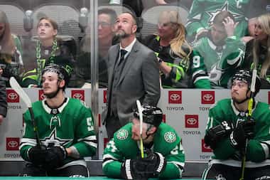 Dallas Stars head coach Pete DeBoer looks on from the bench during the third period in Game...