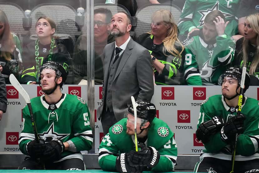 Dallas Stars head coach Pete DeBoer looks on from the bench during the third period in Game...