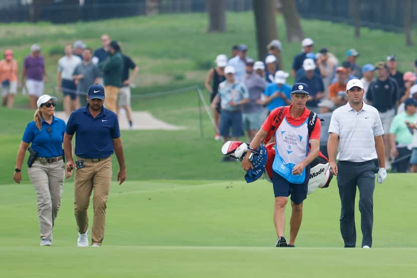 Jason Day (left) and Scottie Scheffler walks towards the eighth hole during the second round...