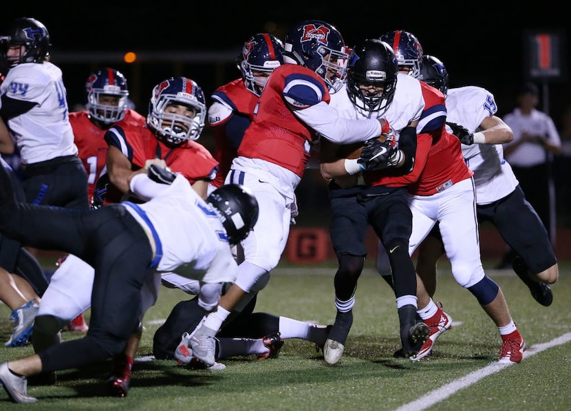 Hebron wide receiver Derek Mueller (5) protects the ball after a failed two-point conversion...