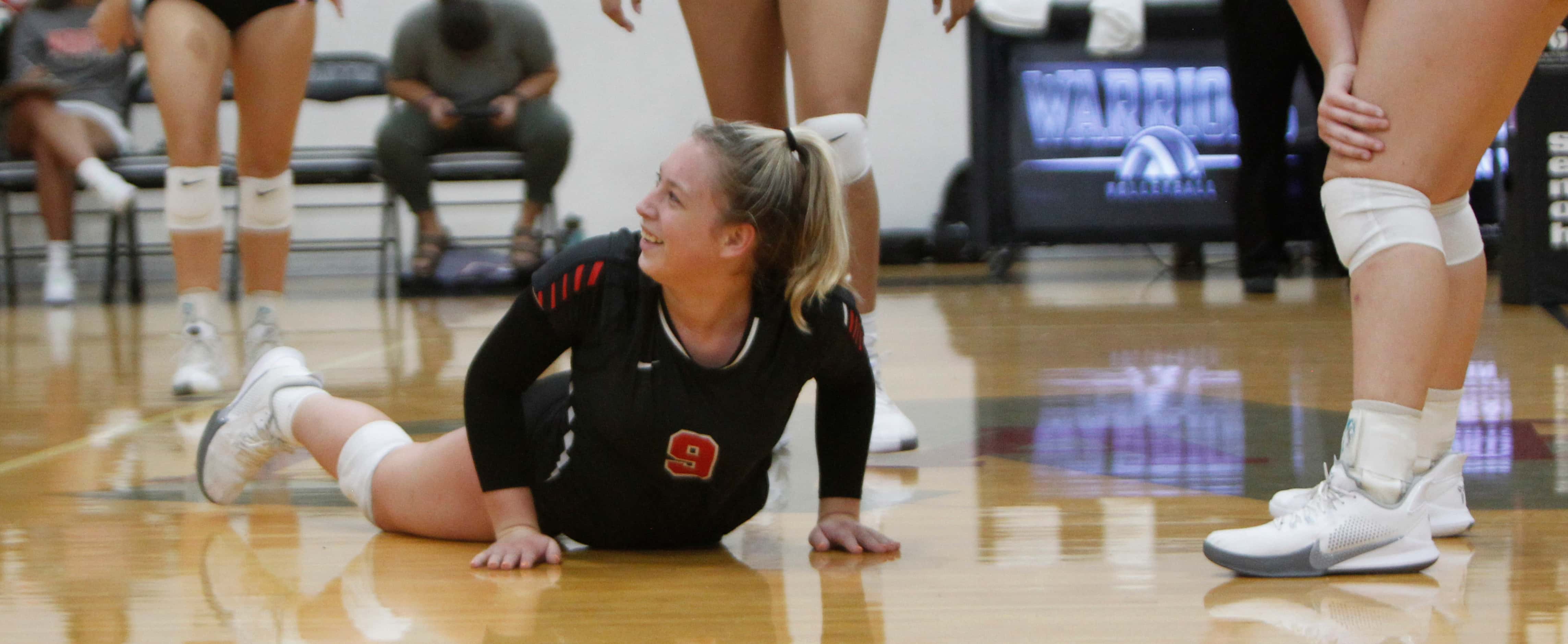 Arlington Martin's Mackenzie Mundell (9) was all smiles as she gets to her feet after making...