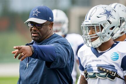 Dallas Cowboys running backs coach Gary Brown  instructs his players during the team's...
