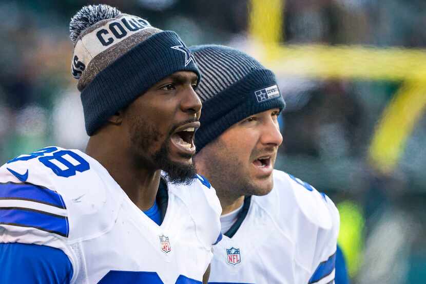 Dallas Cowboys quarterback Tony Romo (9) and wide receiver Dez Bryant (88) watch from the...