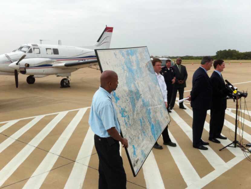 County Judge Clay Jenkins and Mayor Mike Rawlings spoke near a Beechcraft aircraft that will...