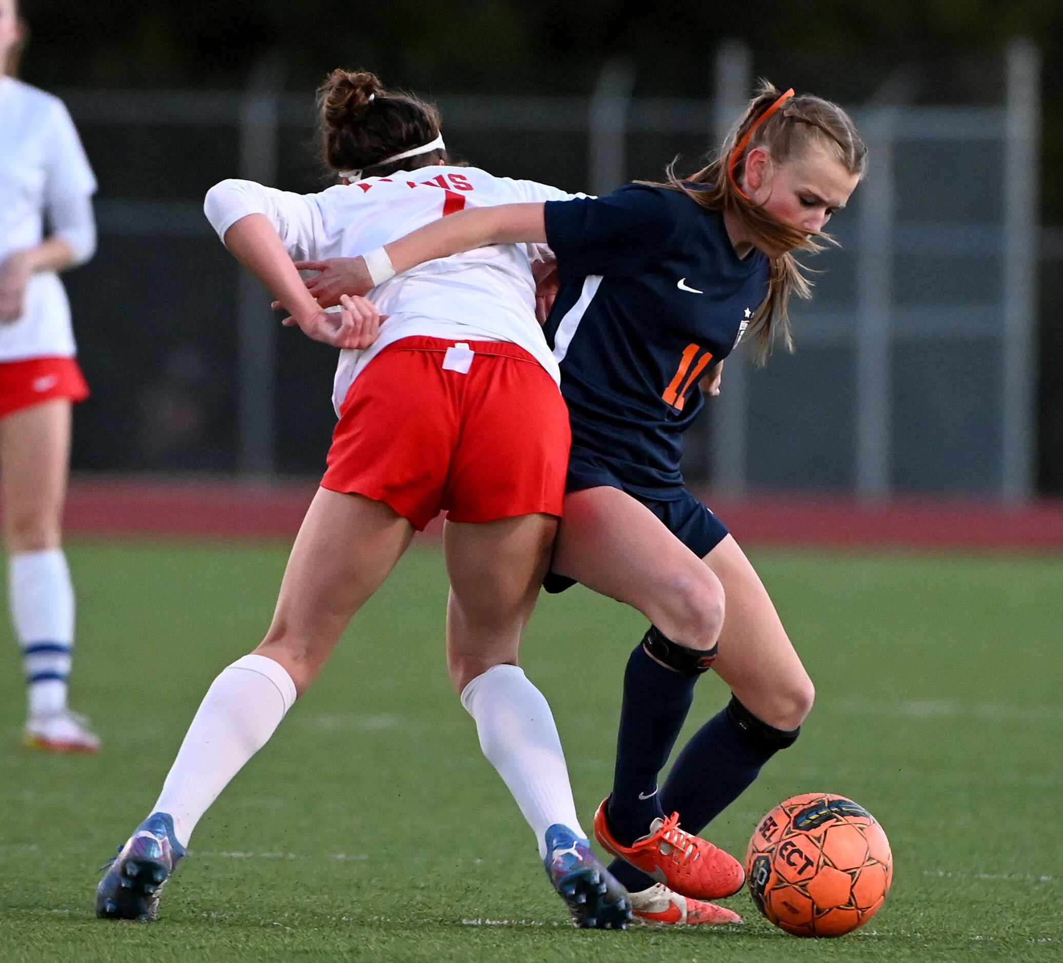 Frisco Wakeland’s Lily Grace Moncrief (11) goes after a ball with Frisco Centennial’s Bella...