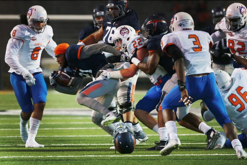 UTEP receiver Eddie Sinegal fights for yardage, minus his helmet, as Houston Baptist...