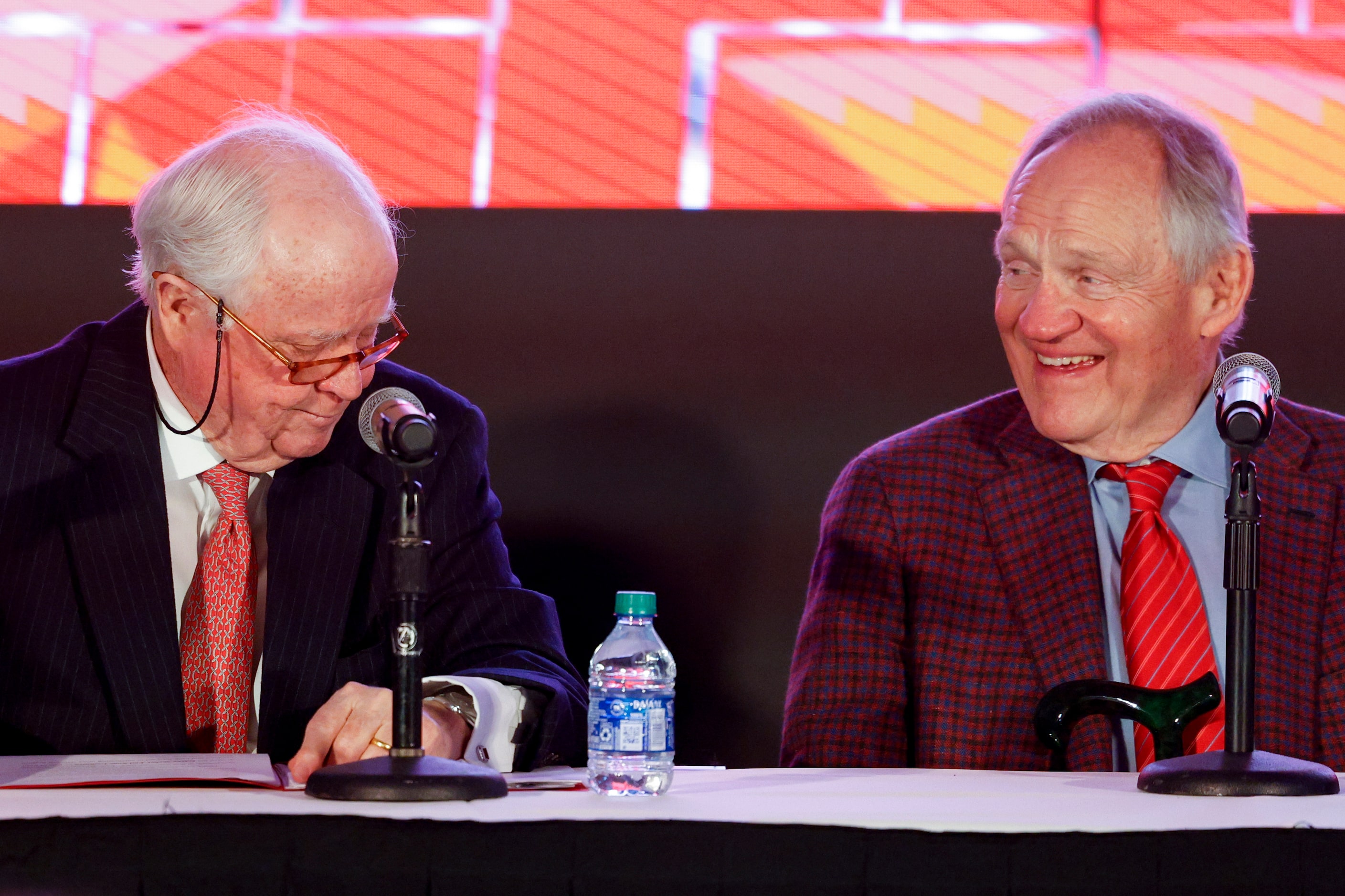 SMU alumnus Garry Weber (right) laughs with SMU alumnus Gerald J. Ford during a press...