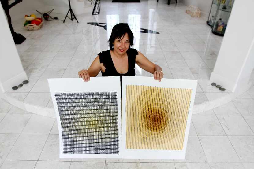 Artist Orna Feinstein, at her home in Bellaire, works with an etching press to create...