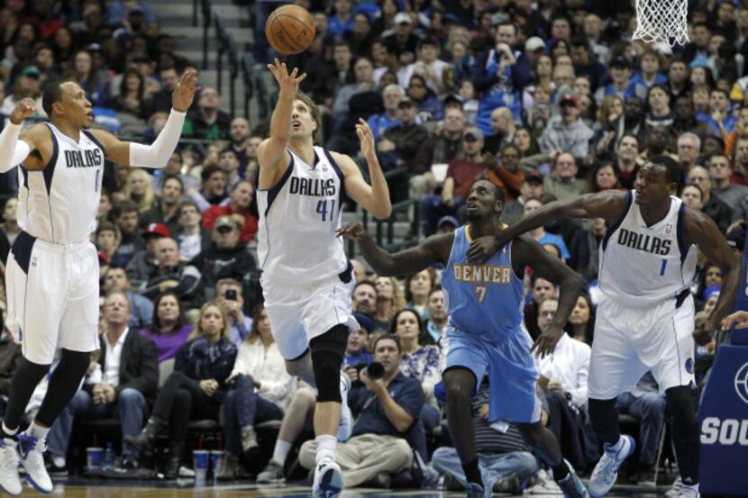 Dallas Mavericks power forward Dirk Nowitzki (41) pulls down a rebound in front of small...