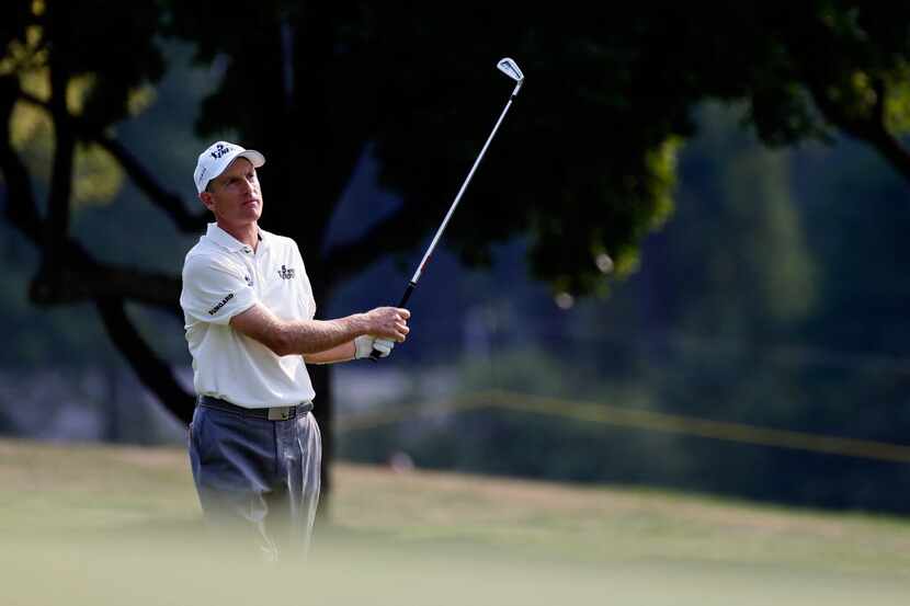 Jim Furyk plays a shot on the 17th hole during the third round of the World Golf...