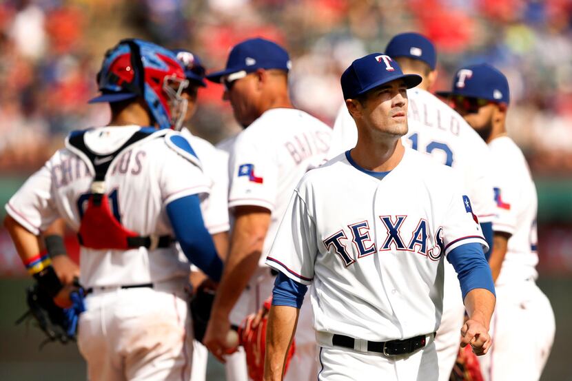 Texas Rangers starting pitcher Cole Hamels walks off the mound after being pulled in the...