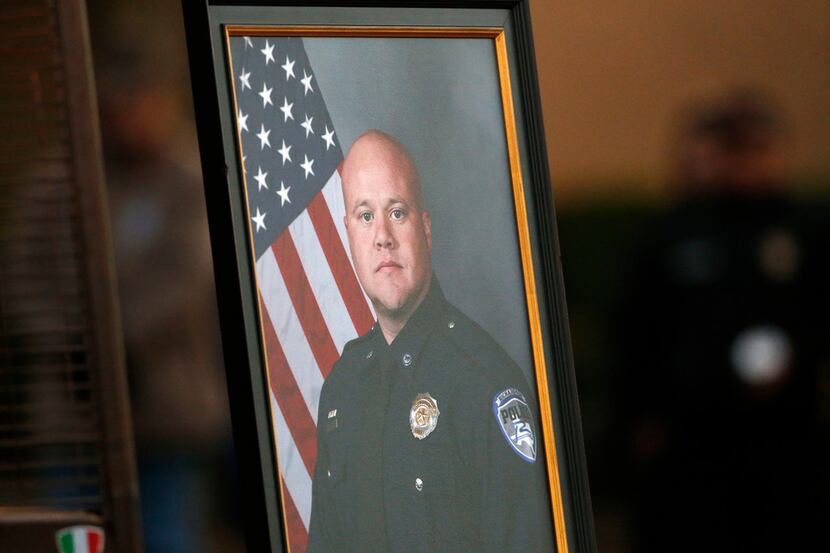 A photo of slain Richardson police Officer David Sherrard was on display during a vigil held...