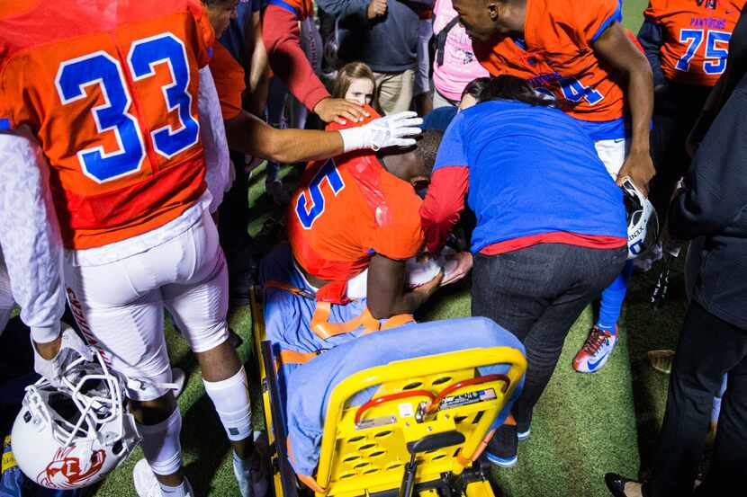 Duncanville quarterback Jaylin Nelson (5) is taken from the field on a stretcher after being...