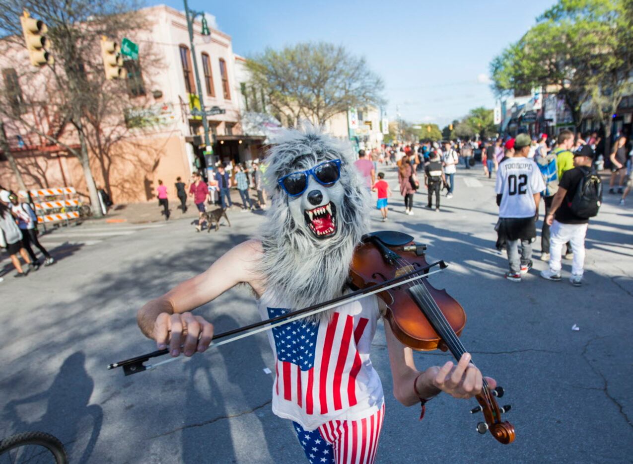 Street performer Violin Monster entertains on Sixth Street during the SXSW music festival on...