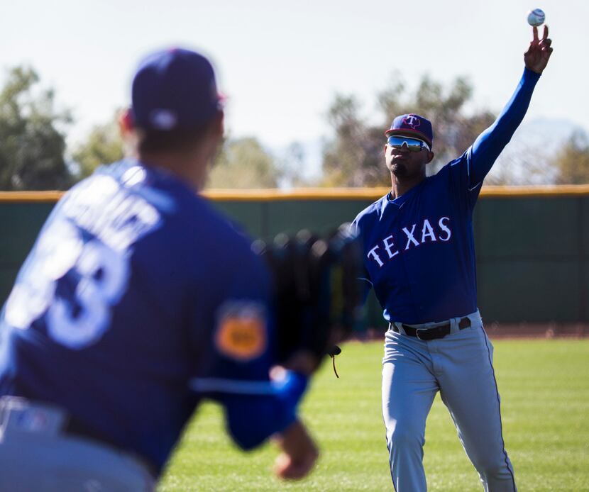 Texas Rangers relief pitcher Yohander Mendez (65) pitches alongside Texas Rangers starting...