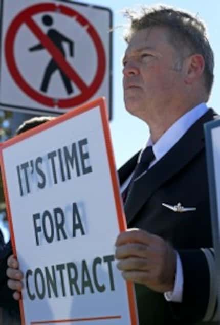  A Southwest Airlines pilot, who was not allowed to identify himself, held a sign in early...