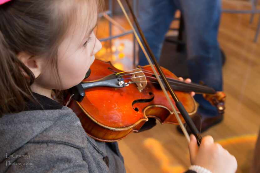 At Family Symphony Sundays, kids can get their hands on the string instruments with the help...