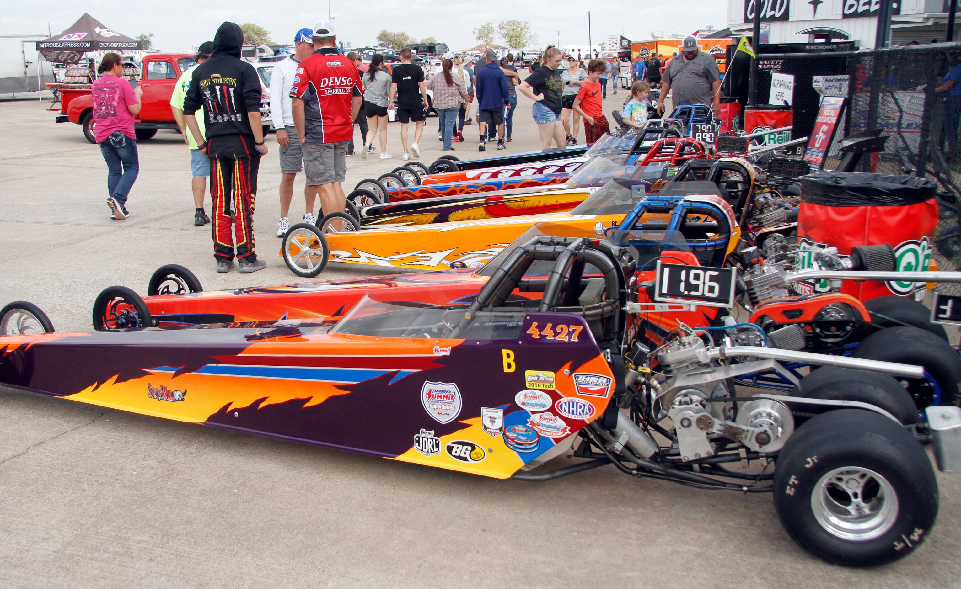 Racing enthusiasts get a close up look at several dragsters on display. The final day of the...