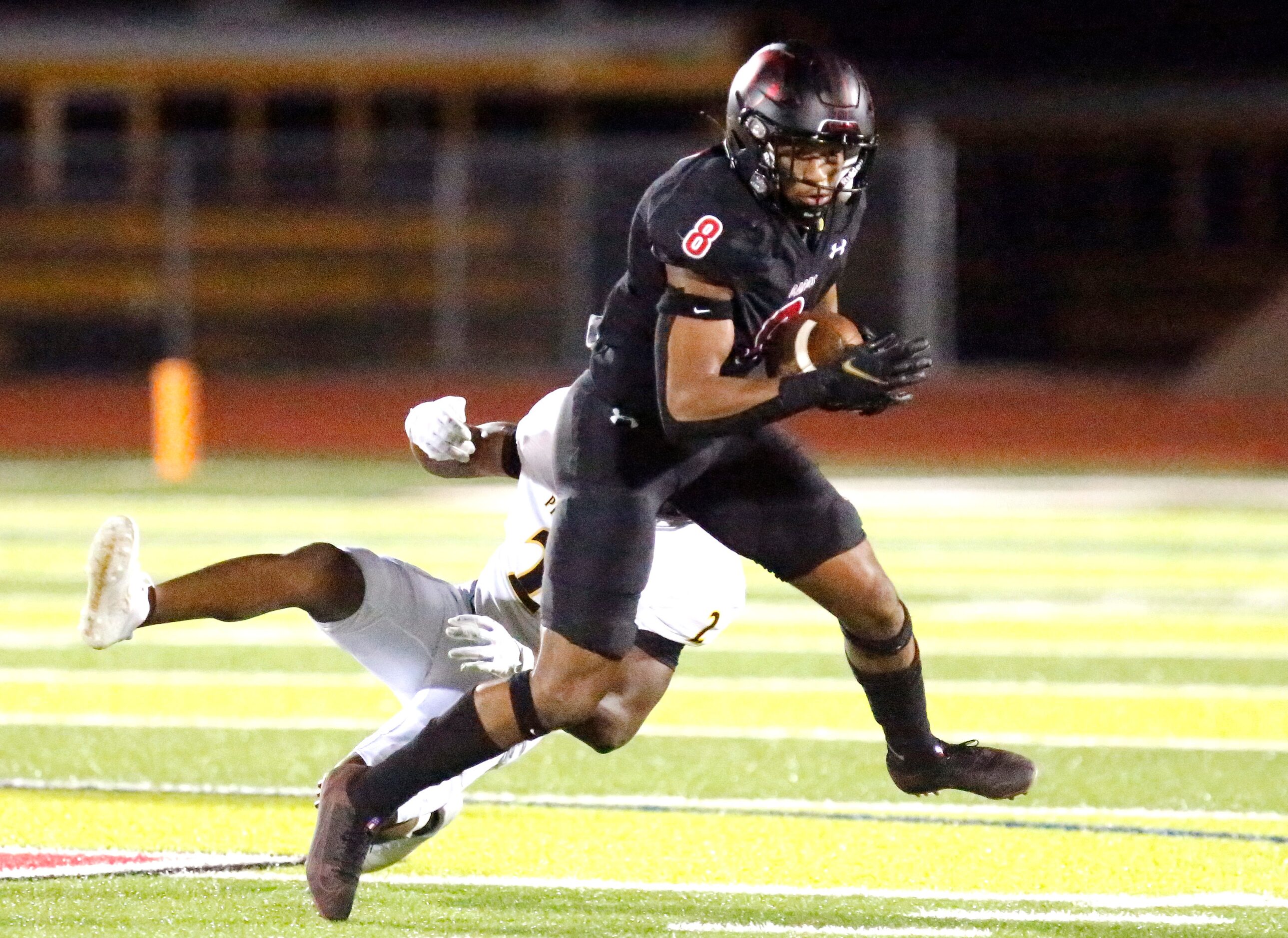 Melissa High School running back Jacob Fields (8)gets past Crandall High defensive back...