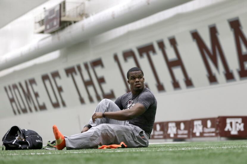 Former Texas A&M running back Trey Williams puts his shoes on before running drills during...