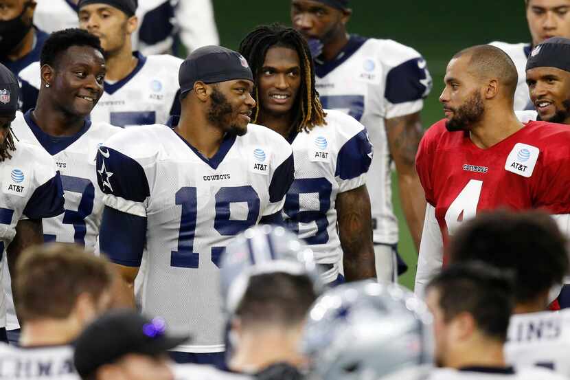 Dallas Cowboys quarterback Dak Prescott (4) talks with Dallas Cowboys wide receiver Michael...