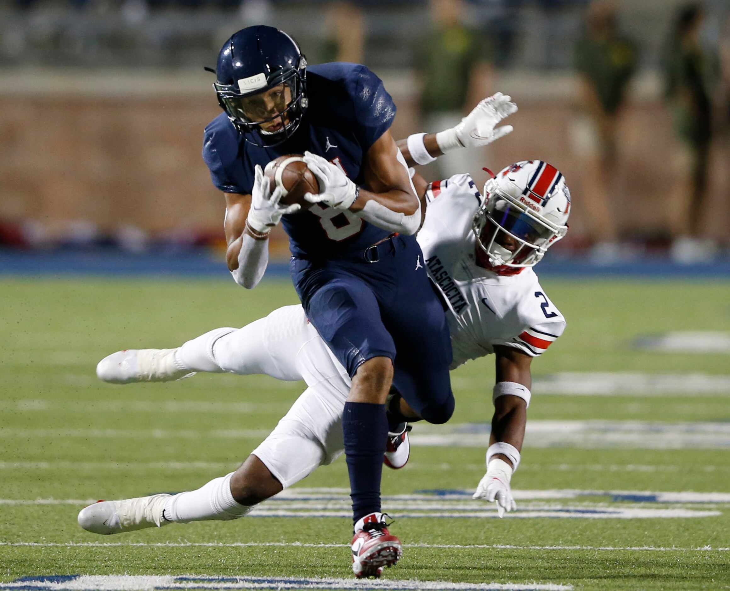 Allen's Blaine Green (8) catches a pass in front of Humble Atascocita's Caleb Burton (2)...