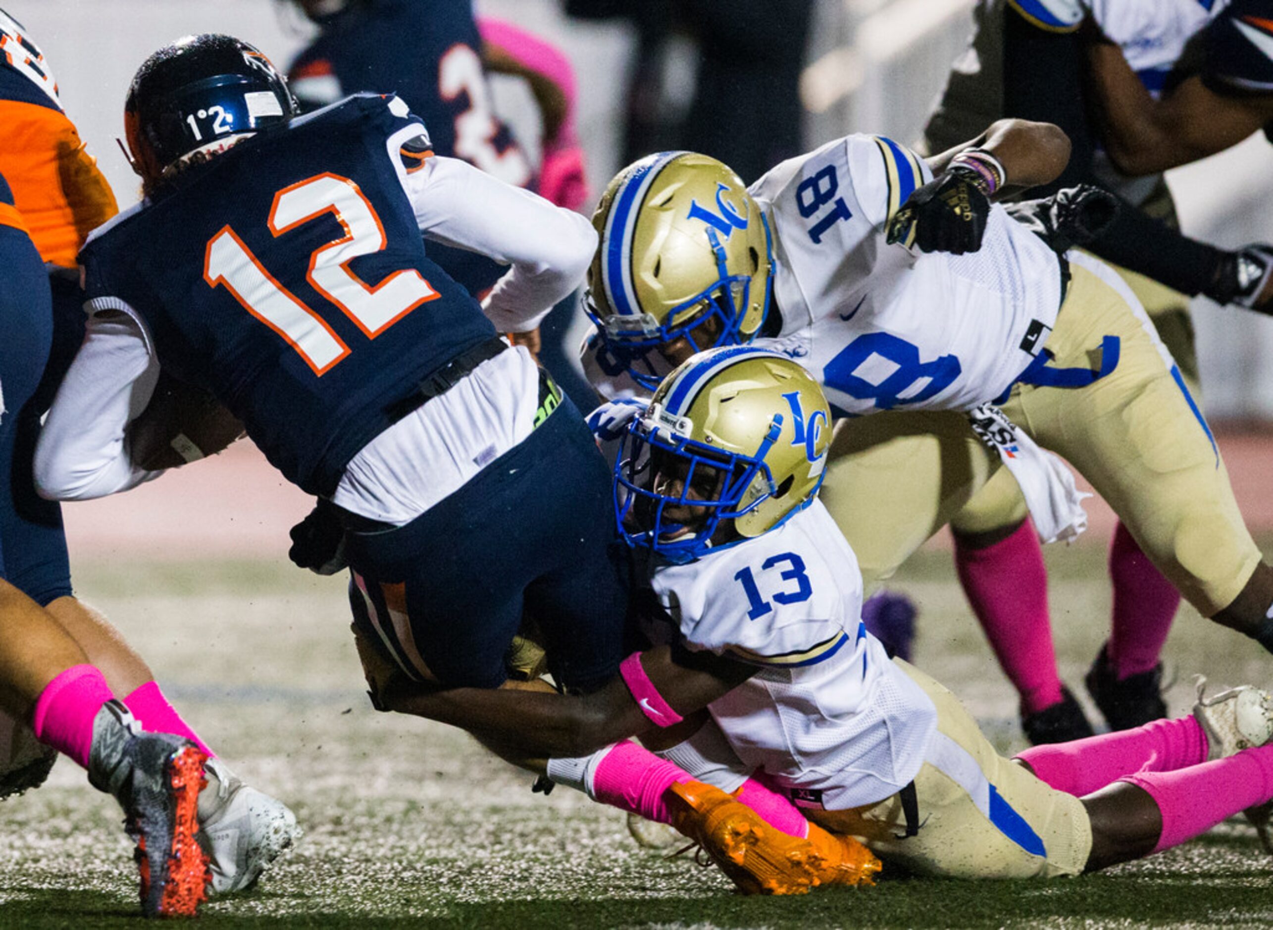 Garland Lakeview linebackers Gavin Harris (13) and Zacchaeus Adams (18) tackle Sachse...