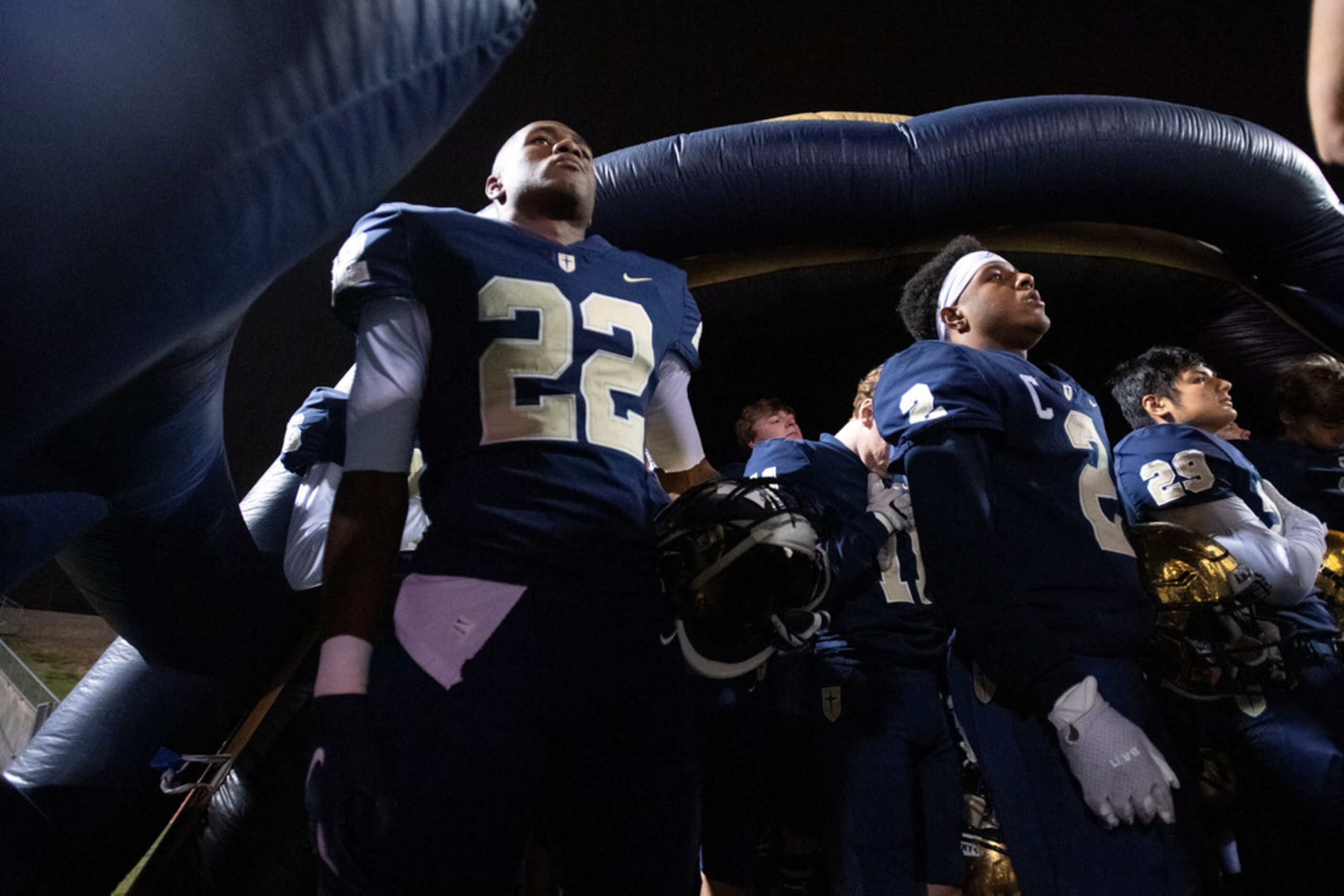 Jesuit senior running back E.J. Smith (22) stands in the inflatable helmet during the...