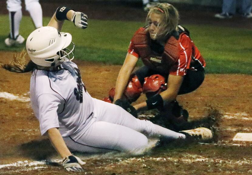 Ennis' Julia Hollingsworth (5) is out at home as she tries to score on a wild pitch, as...