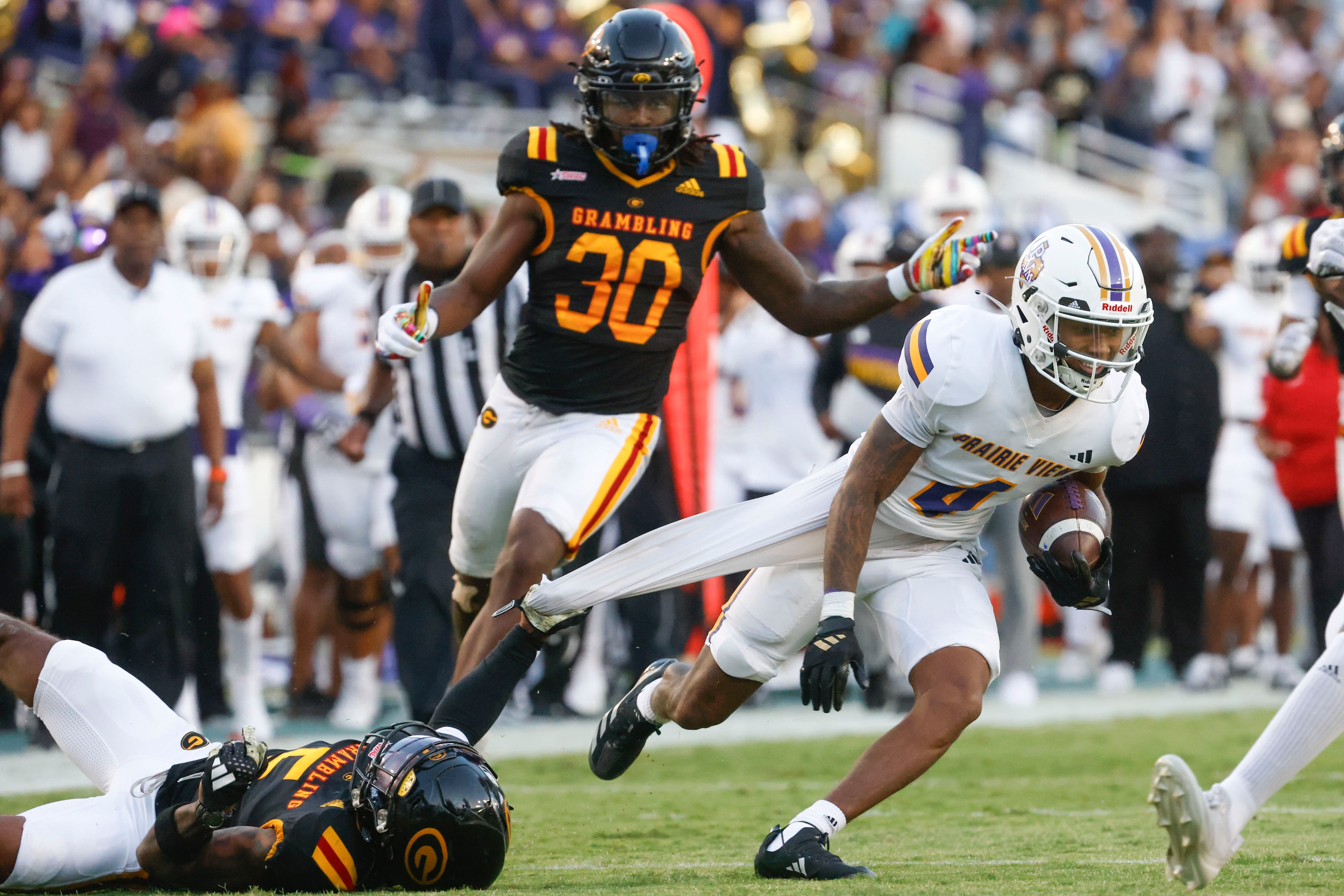 Grambling State defensive back Calvin Henderson (left) holds on to Prairie View A&M wide...