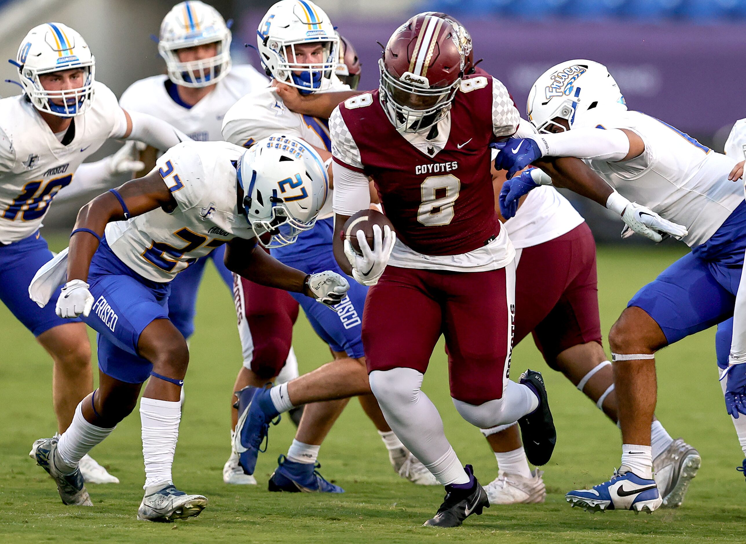 Frisco Heritage running back Danzel Okekeuche (8) tries to break free from Frisco defensive...