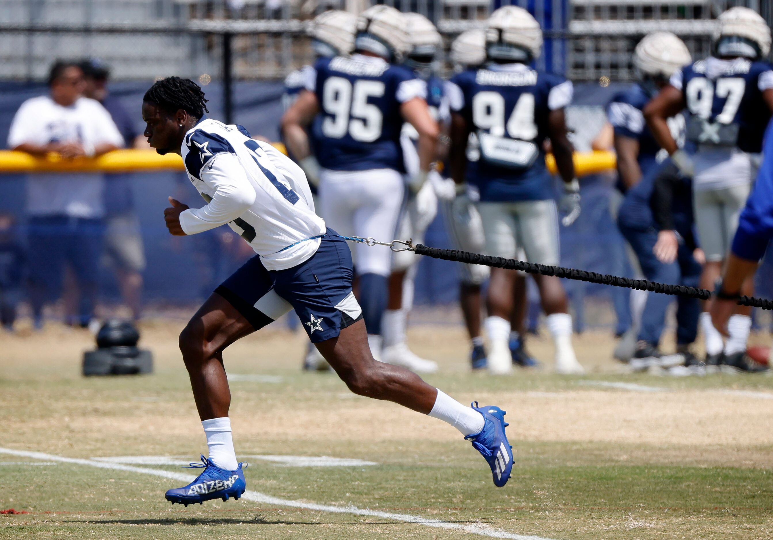 Dallas Cowboys wide receiver Michael Gallup (13) uses a resistance cord to work on his...