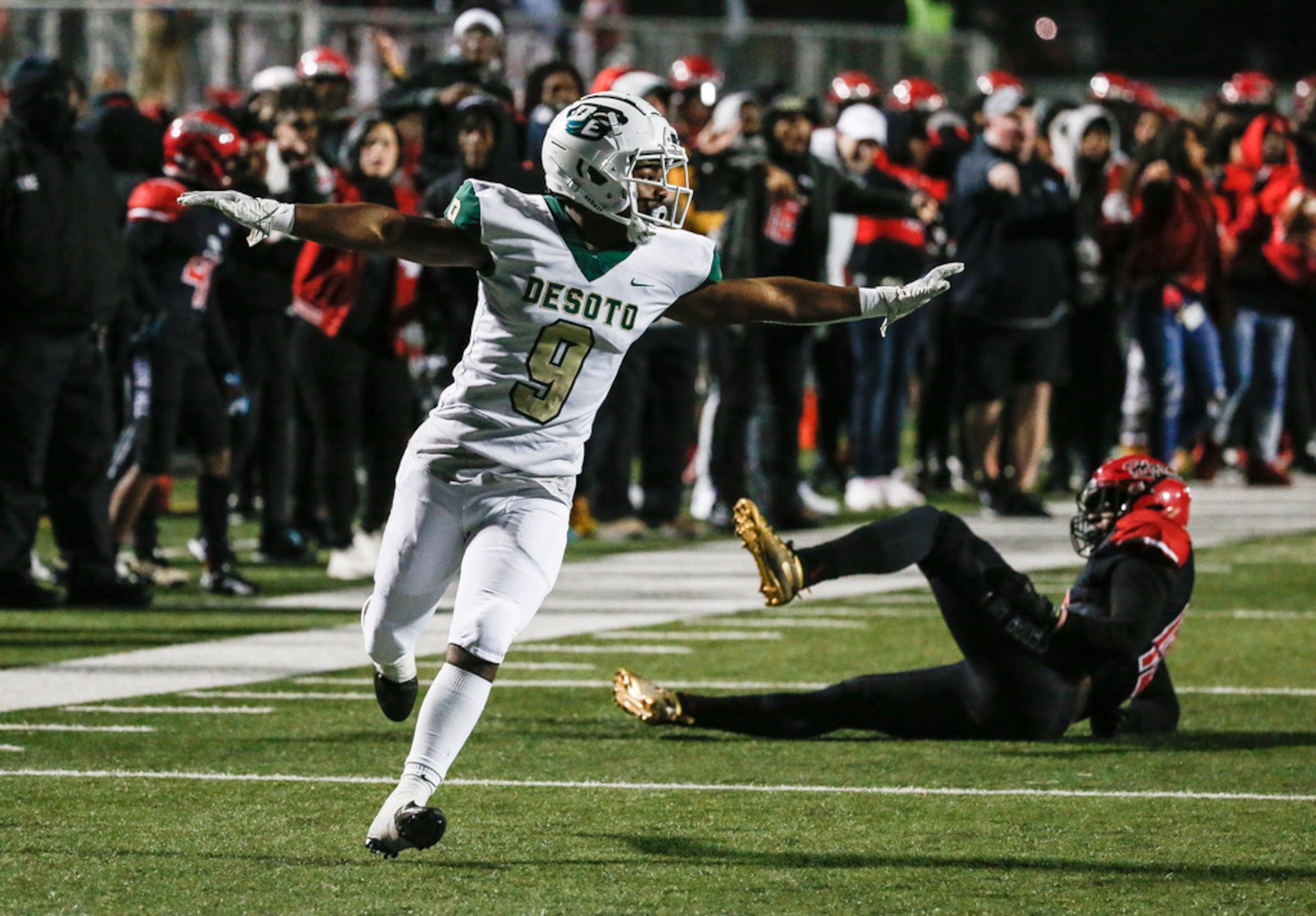 DeSoto Ridarius Branch (9) celebrates a stop of Cedar Hill running back Corrie Allen (10)...