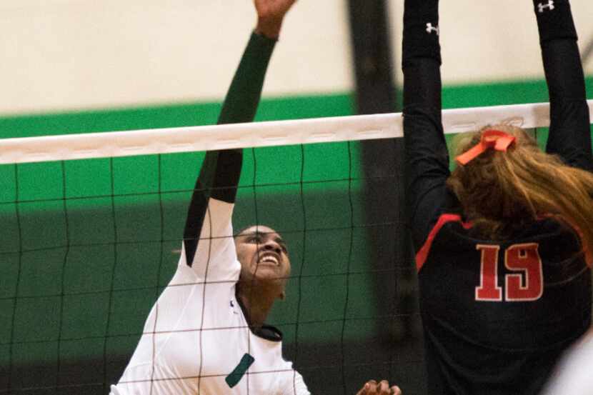 Mansfield Lake Ridge outside hitter Madison Williams (1) spikes against Lovejoy in the Class...