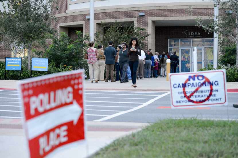 A line forms outside a polling site on Election Day, Tuesday, Nov. 8, 2016, at the IDEA...