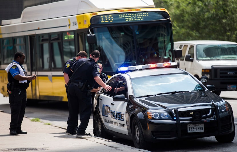 DART officers work near a DART police car on Thursday, August 3, 2017 near the West End DART...